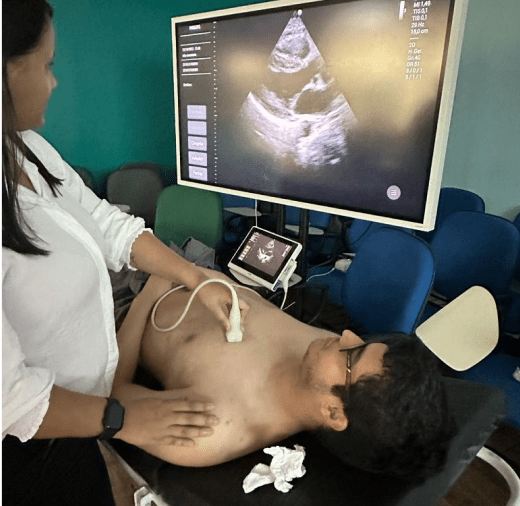 Student explaining ultrasound results to another student during demonstration in Brazil