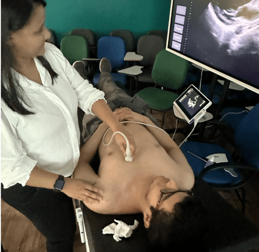 Student explaining ultrasound results to another student during demonstration in Brazil