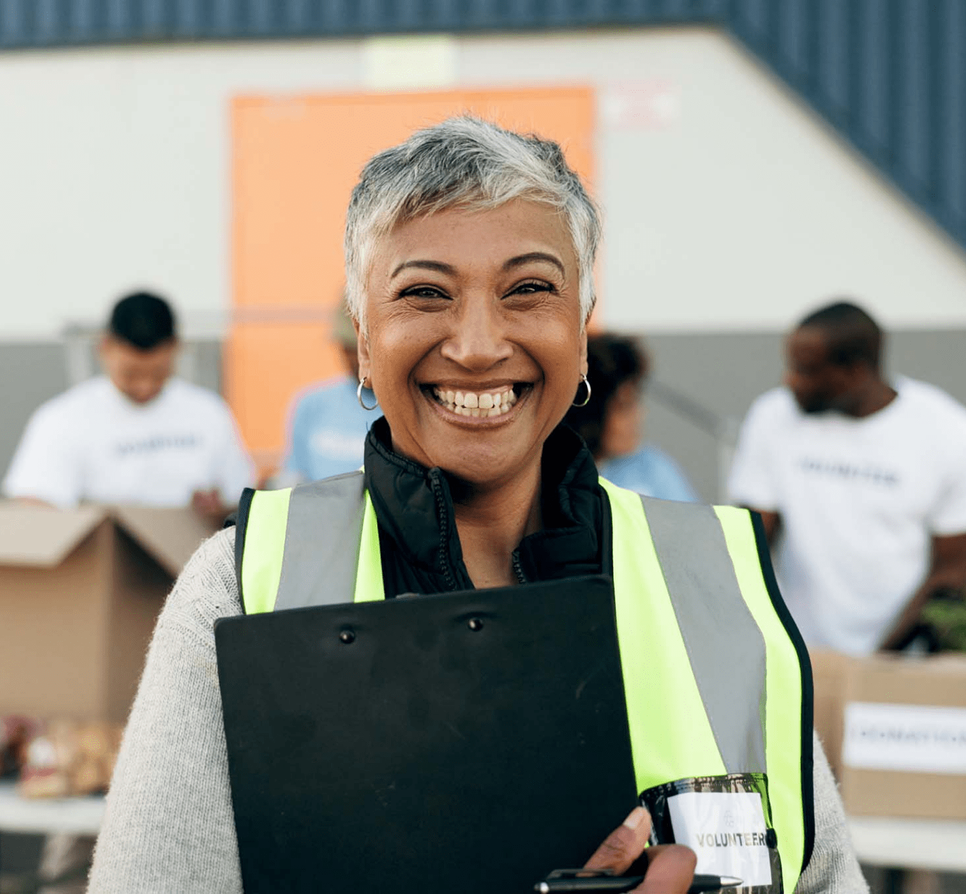 Smiling volunteer at a drive to generate support for their community