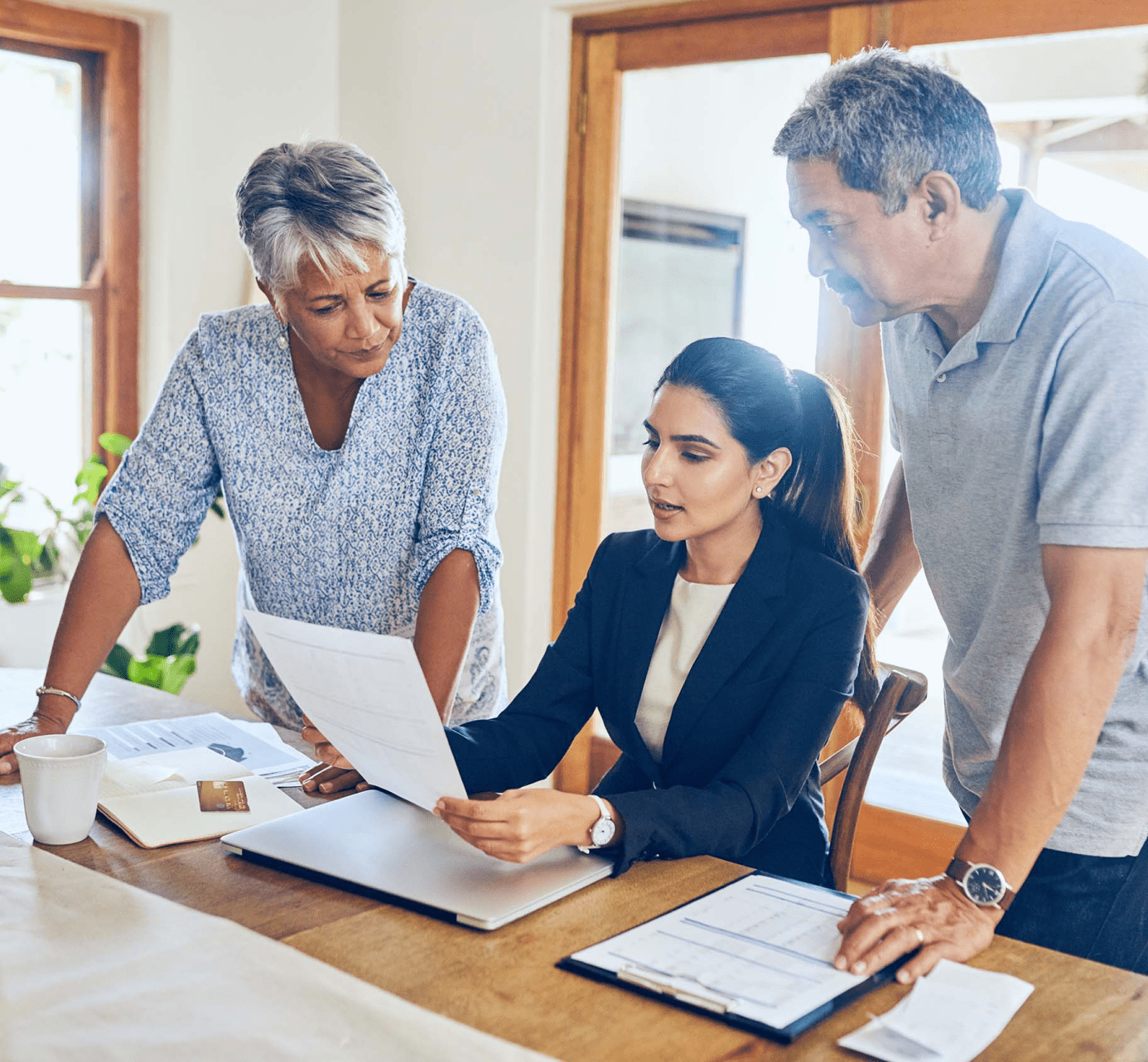 Accountant reviewing financials with aging couple for legacy giving