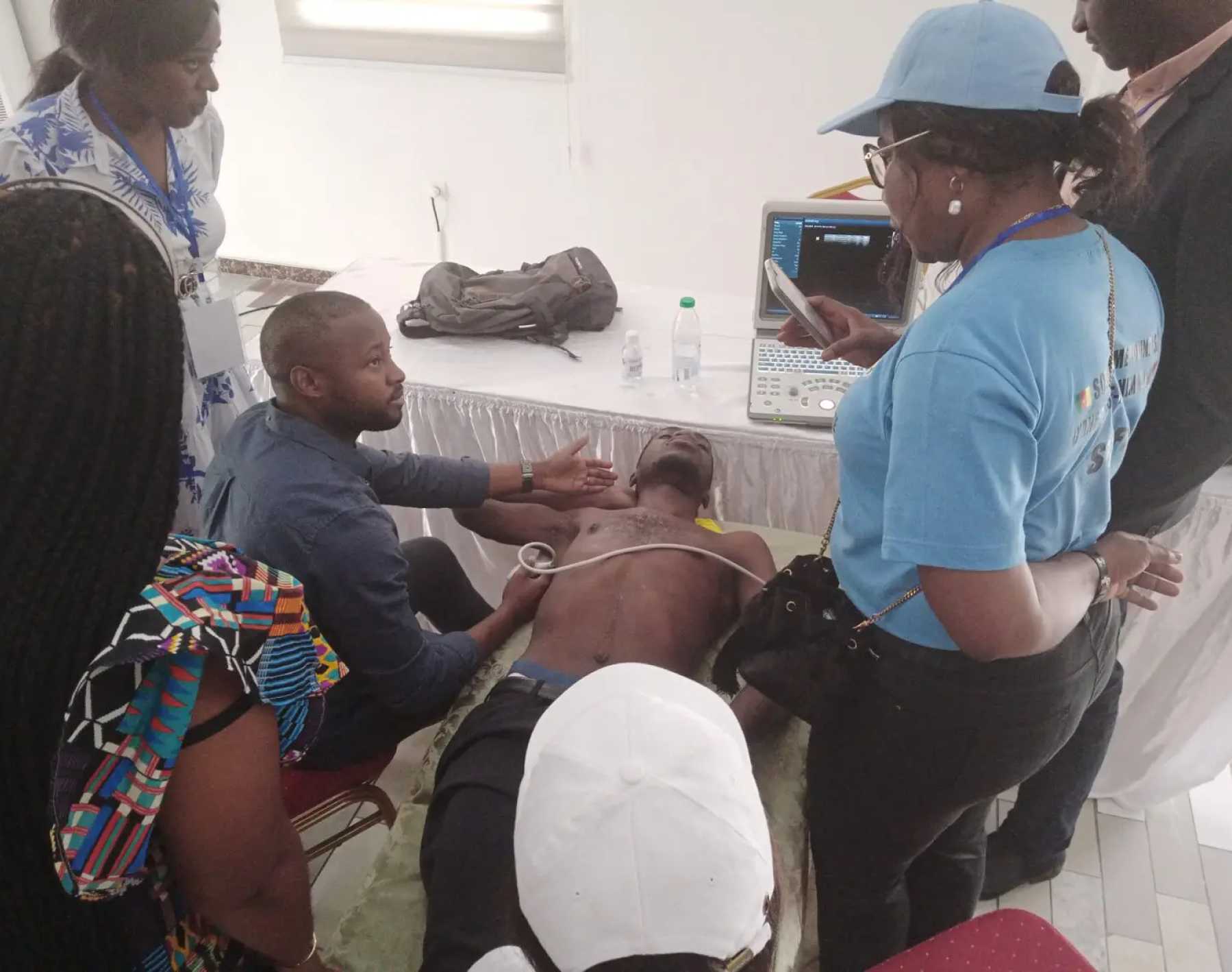 Medmission in action with team member providing Ultrasound demonstration for multiple students