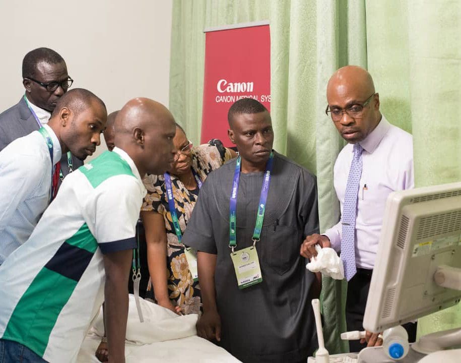 Medical students gathered around an ultrasound demonstration at presentation in Nigeria